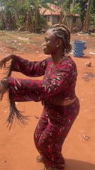 Woman dances in traditional outfit in Ogbe, Nigeria