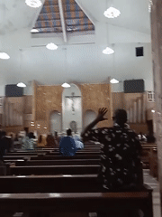 Church service observed with standing congregants at evening hour