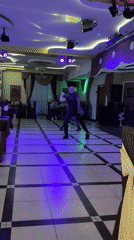 Couple performs dance routine with light whip in Miass ballroom
