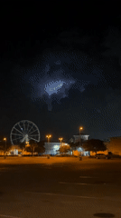 Ferris wheel lights glow over a quiet Panama City Beach night.