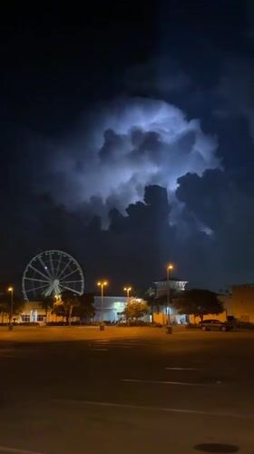Ferris wheel lights glow over a quiet Panama City Beach night.