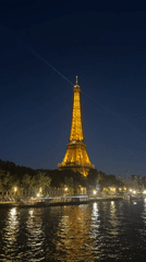 Eiffel Tower illuminated golden against evening skies in Paris