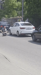 Man skateboards through Krasnodar streets near justice sculpture