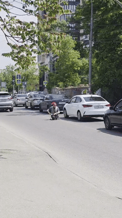 Man skateboards through Krasnodar streets near justice sculpture