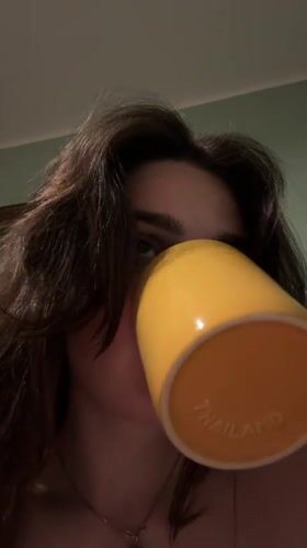 Person drinks from Thailand mug in Bratislava home