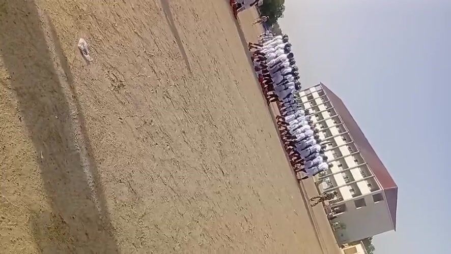 Uniformed group assembles on dirt field in Maiduguri