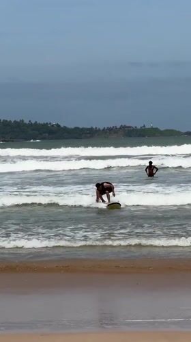 Morning beach activities and surfing lessons observed at Weligama