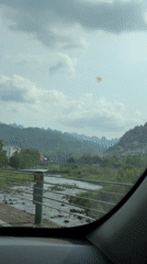 Vehicle captures scenic river view while driving through Wulingyuan