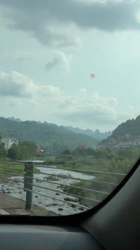 Vehicle captures scenic river view while driving through Wulingyuan