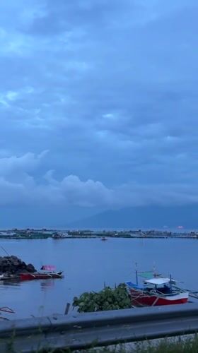 Woman films evening stroll along Davao City waterfront walkway