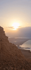 Sunrise captured from rocky Israeli mountain overlooking water