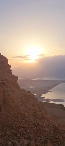 Sunrise captured from rocky Israeli mountain overlooking water