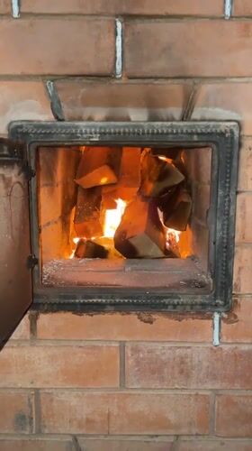 Wood fire burns in brick oven, Sestroretsk Russia