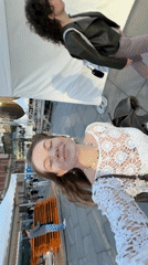Woman Takes Selfie in Belgrade While Passerby Walks Behind