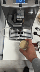 Coffee drink placed near espresso machine in Moscow