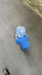 Woman takes selfies while child rides scooter in Moscow