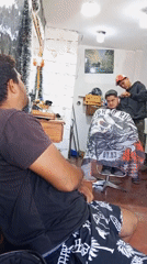 Evening barber shop activity documented in urban commercial district