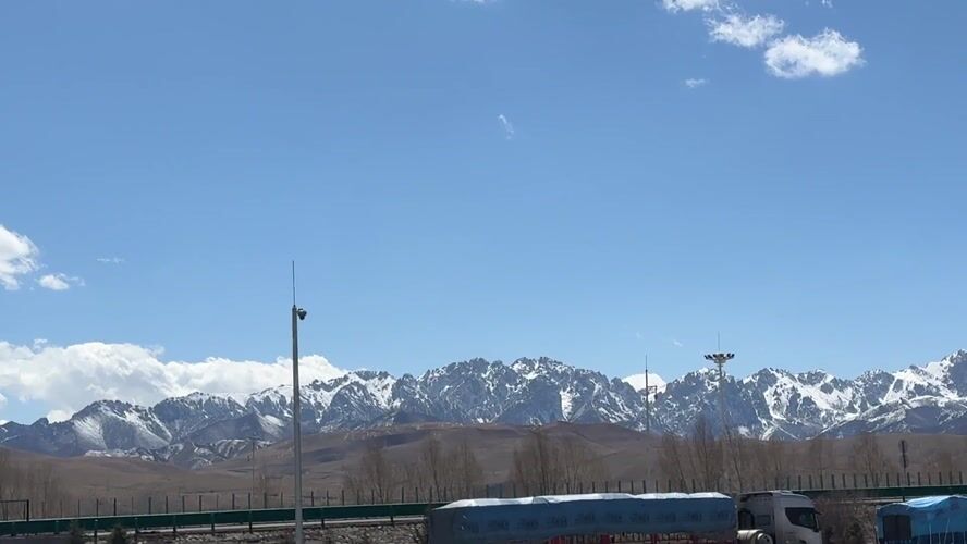 Morning parking scene documented in Wuwei with mountain backdrop