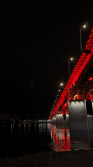 Red-lit Krasnoyarsk bridge captures nighttime attention along Yenisey River