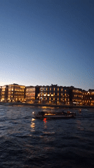 Waterfront stadium and city lights at dusk