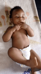 Family moments captured: baby, woman, children share tender blanket time