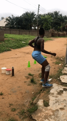 Woman conducts morning exercise routine in Akwanga dirt yard