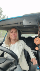 In-car vlog moment with a Faberlic lip gloss in hand