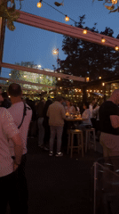 Evening outdoor dining gathering with DJ entertainment documented