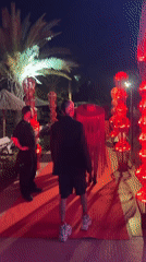 Three men gather on decorated red carpet in Kemer