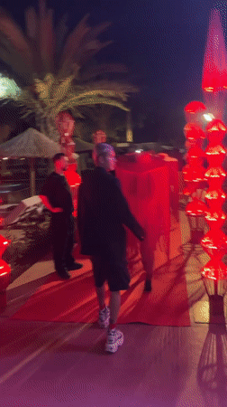 Three men gather on decorated red carpet in Kemer