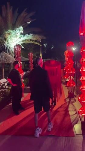 Three men gather on decorated red carpet in Kemer