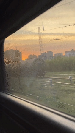Train passenger films sunset over Ryazan city skyline