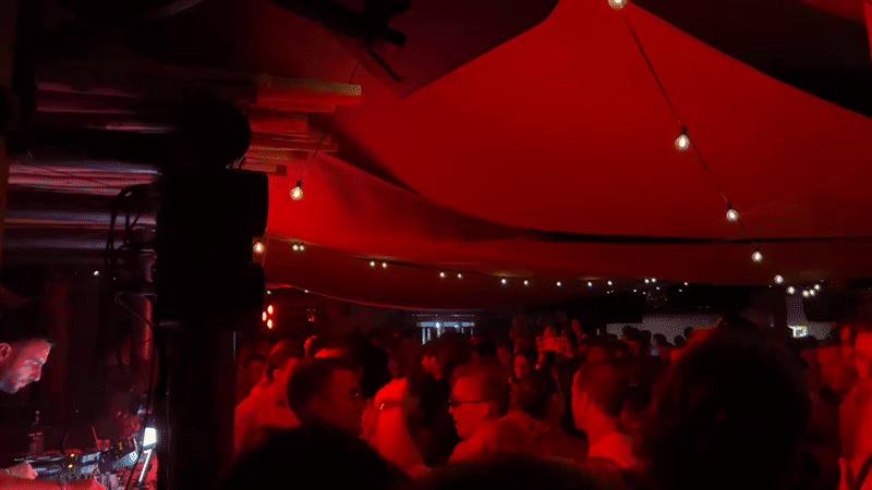 Late-night club scene in Ramatuelle under red lights