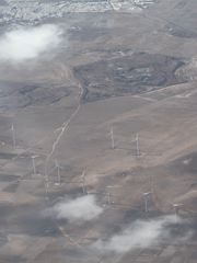 Wind farm spotted across barren landscape near Teguise, Spain