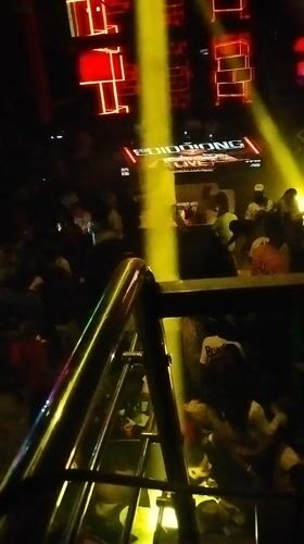 Person elevated above crowd at Nigeria nightclub venue