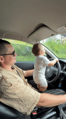 Toddler at the wheel of a moving car in rural Russia