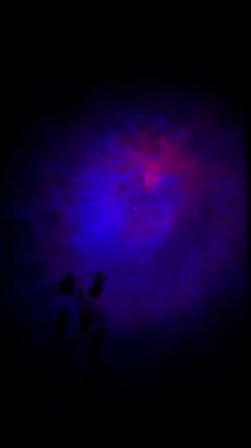Colorful space projector lights fill a dark room in Shushary