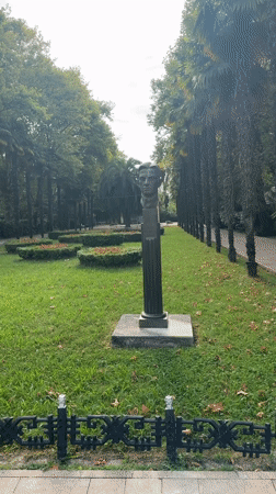 Strolling through a palm-lined ornamental garden in Sochi