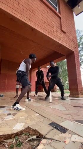 Young men perform dance routine in Kuru Karama, Nigeria