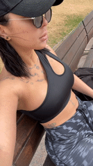 Woman in athletic wear sits on bench in l'Hospitalet