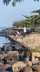 A quiet day along Manado's harbor and rocky shoreline