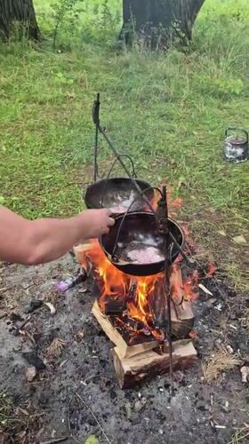 Campsite in rural Russia: tents, open fire, and cast iron cooking
