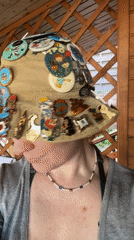 Pin collector displays decorated hat in Nizhny Novgorod gazebo