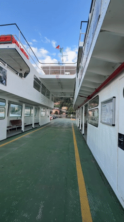 Ferry crossing an Italian lake with car and crew on deck