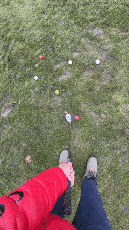 Golfer practices putting with colorful balls in Coquitlam
