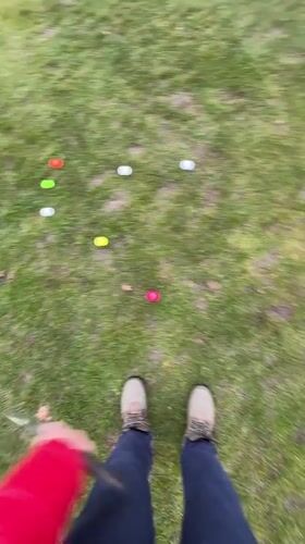Golfer practices putting with colorful balls in Coquitlam