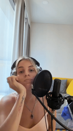 Woman records music in Bangkok home studio session