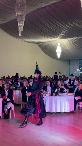 Traditional dance and music performance at a formal indoor celebration
