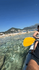 Tourist documents scenic Budva coastline during morning exploration