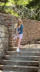 Tourist poses for photos at scenic Sveti Stefan overlooks
